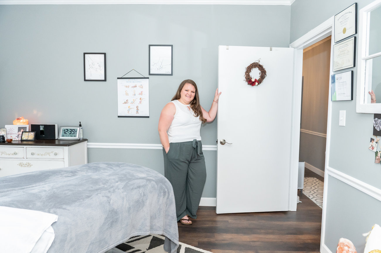 Deandra standing at the door of her office, smiling.
